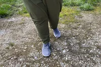 A person wearing the Allbirds Tree Runners outdoors
