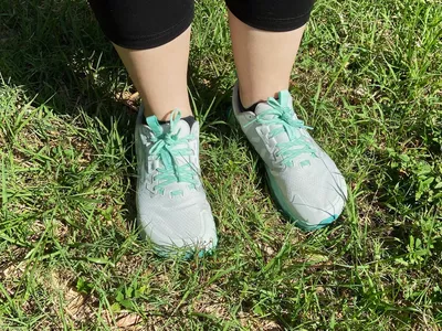 Person wearing Altra Women's Lone Peak 7 Trail Running Shoes on grass