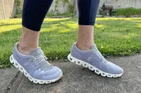 Person wearing ON Cloud 5 Sneakers on sidewalk