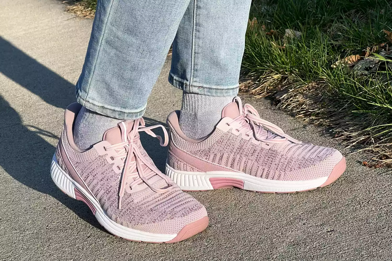 Person wearing Orthofeet Women's Kita Hands-Free Athletic Sneakers on a sidewalk