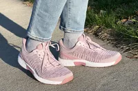 Person wearing Orthofeet Women's Kita Hands-Free Athletic Sneakers on a sidewalk