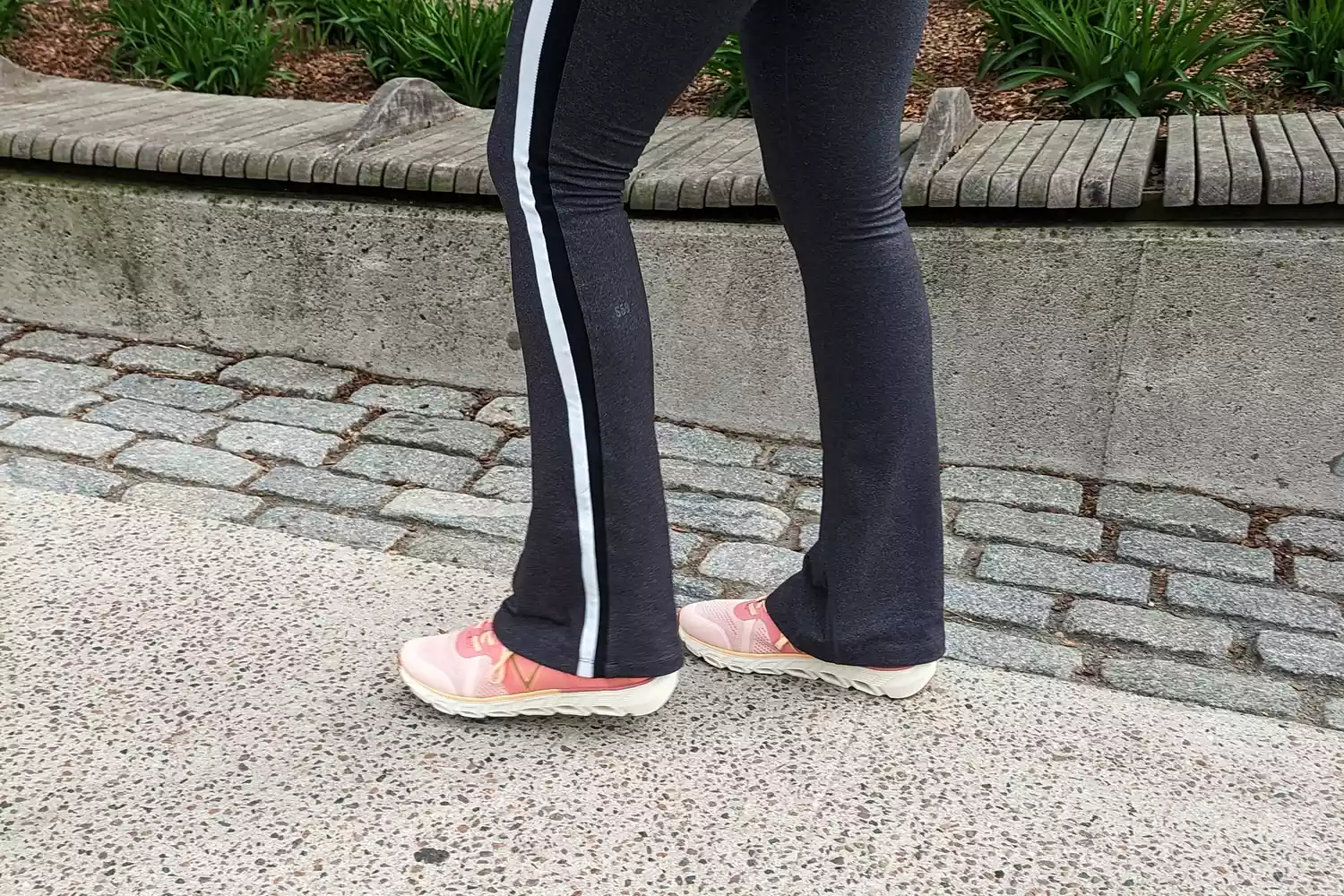 A close-up of Vionic Captivate sneakers worn on concrete