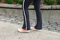 A close-up of Vionic Captivate sneakers worn on concrete