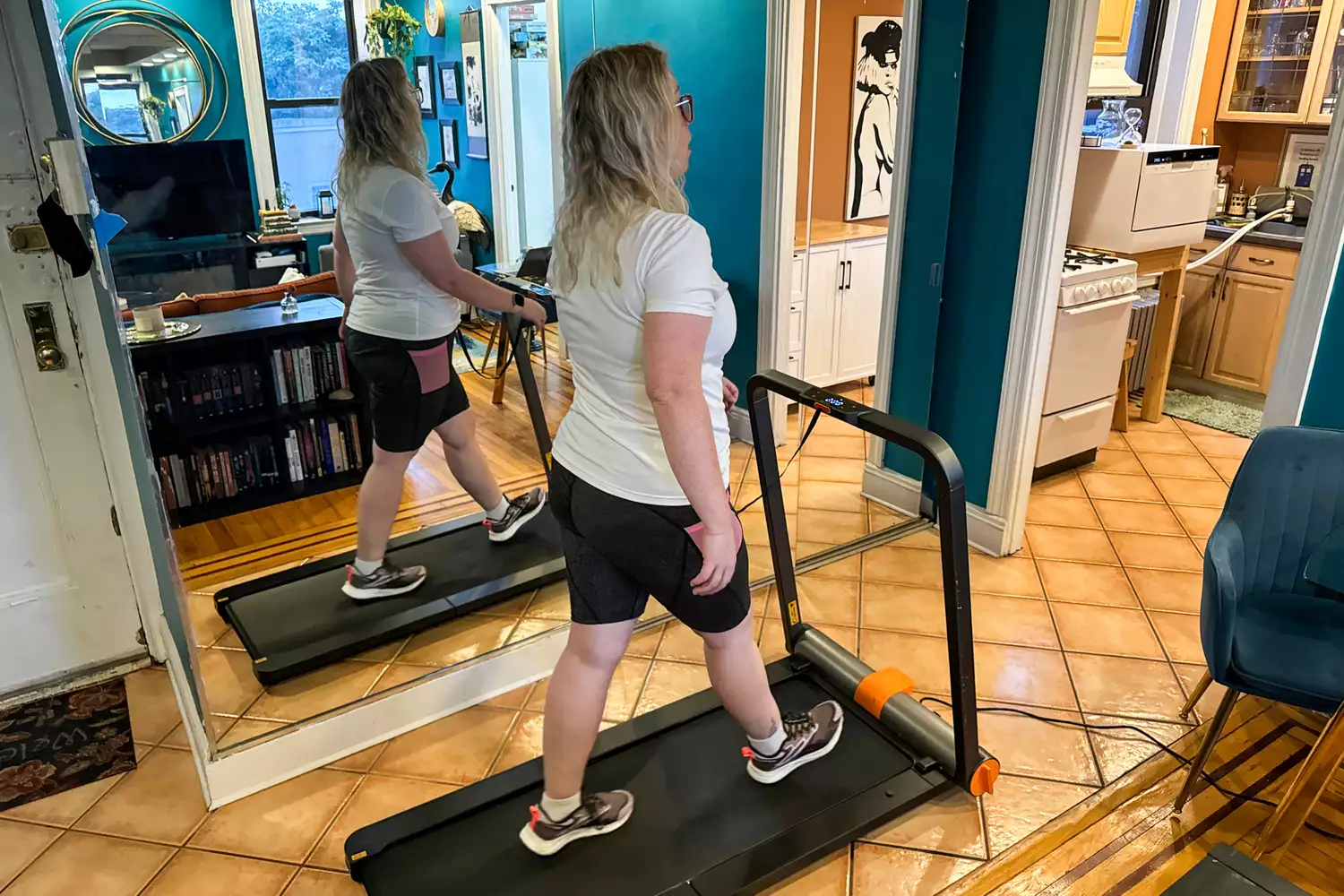 A person walks on the WalkingPad MC11 Workout Treadmill