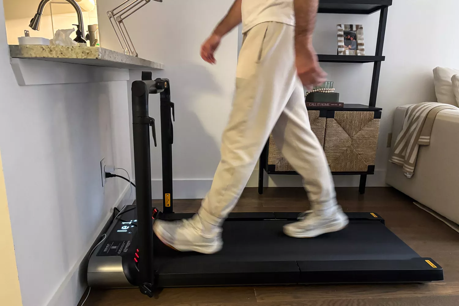 A side view of a person walking on the WalkingPad R3 Hybrid Foldable Treadmill
