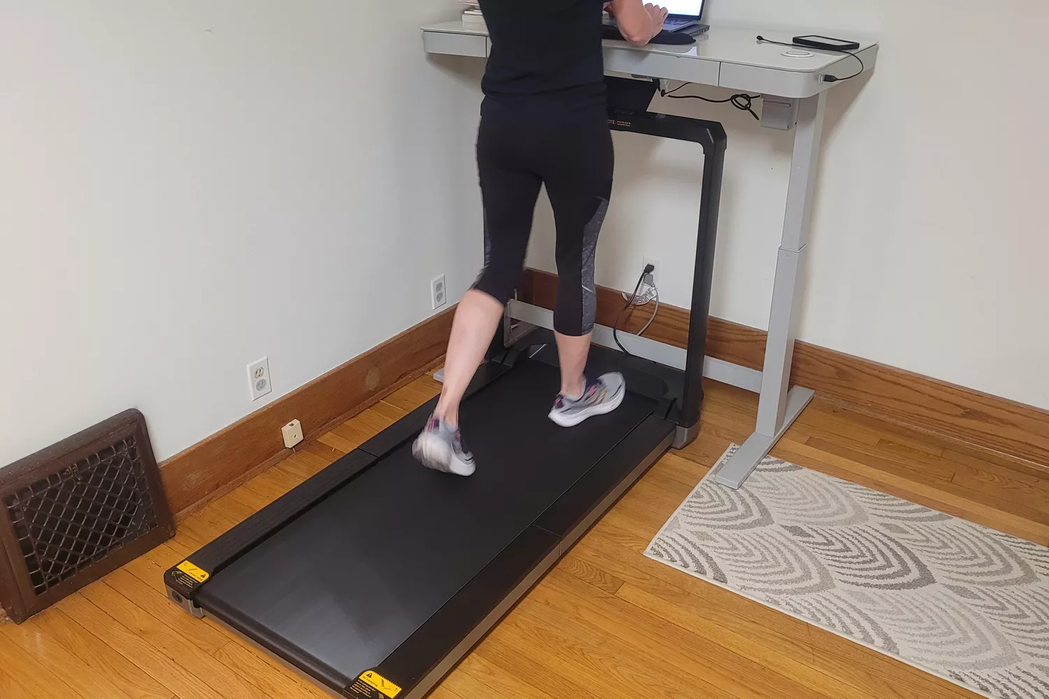 A person walks on the WalkingPad X25 Double-Fold Running Treadmill