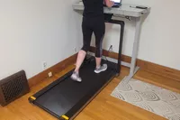 A person walks on the WalkingPad X25 Double-Fold Running Treadmill