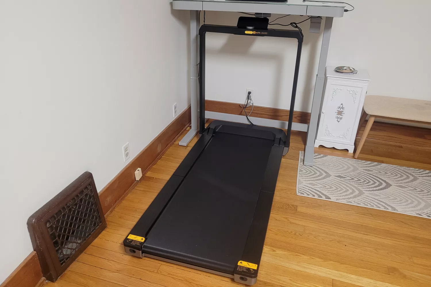 The WalkingPad X25 Double-Fold Running Treadmill under a desk in a home office