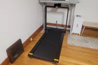 The WalkingPad X25 Double-Fold Running Treadmill under a desk in a home office