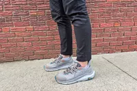 A person wears a pair of Hoka Men's Kaha 2 Low GTX Hiking Shoes