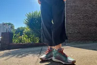 A person stands outside on concrete while wearing the Nike Women's Pegasus Trail 4 GORE-TEX Running Shoes