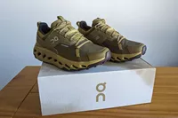 A pair of On Running Women's Cloudhorizon Waterproof Running Shoes on a shoebox