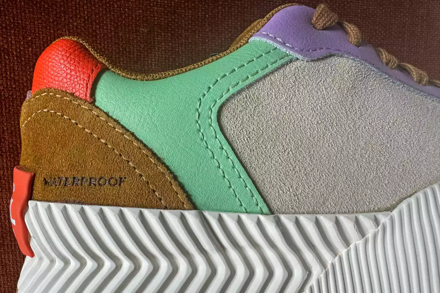 A closeup of the logo on the Sorel ONA Blvd Classic Womenâs Waterproof Sneaker