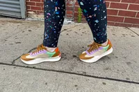 A person walks outside on concrete while wearing the Sorel ONA Blvd Classic Womenâs Waterproof Sneakers