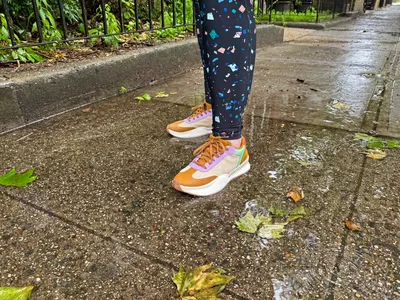 A person stands outside while wearing the Sorel ONA Blvd Classic Womenâs Waterproof Sneakers