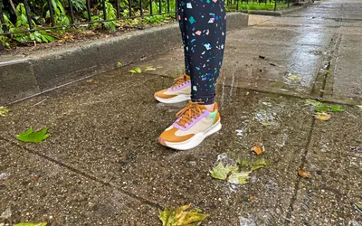 A person stands outside while wearing the Sorel ONA Blvd Classic Womenâs Waterproof Sneakers