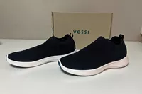 A pair of Vessi Men's Everyday Move Slip Ons in front of a shoebox
