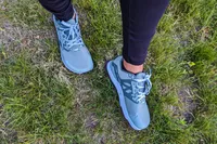 The Altra Lone Peak 8 Trail Running Shoes worn on grass