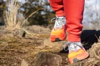 A close-up of the Altra Running Morailnt Blanc Carbon Menâs Trail Running Shoe worn on a trail