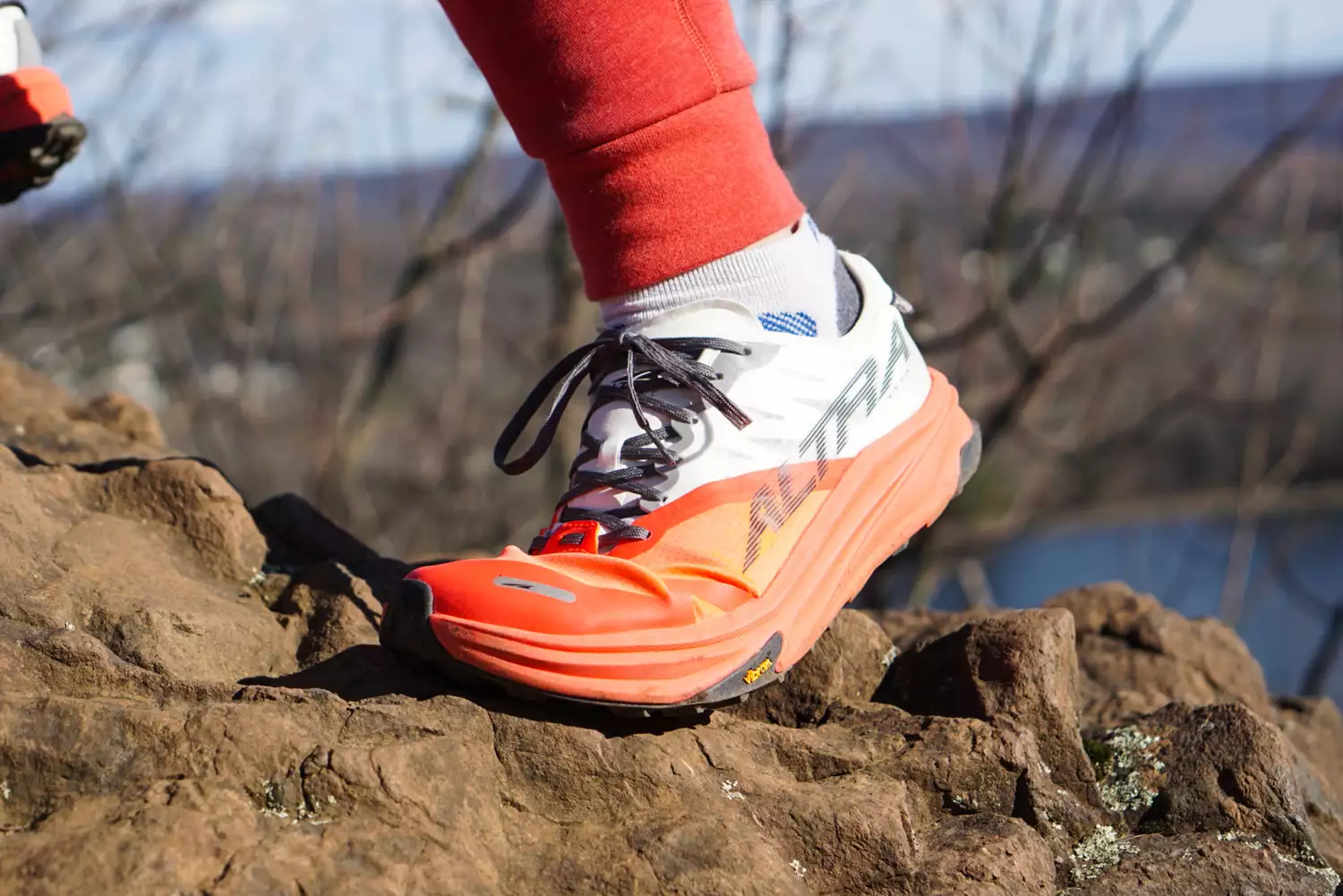 A close-up of the Altra Running Mont Blanc Carbon Menâs Trail Running Shoe stepping on a rock