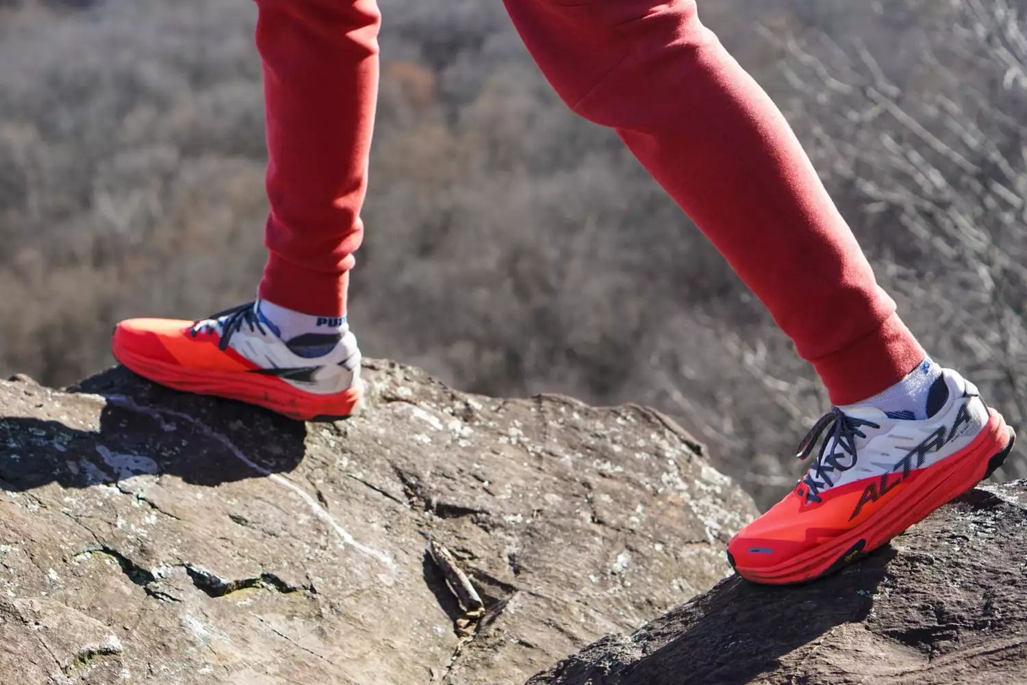A close-up of a person stepping on a rock while wearing the Altra Running Mont Blanc Carbon Menâs Trail Running Shoes