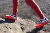 A close-up of a person stepping on a rock while wearing the Altra Running Mont Blanc Carbon Menâs Trail Running Shoes