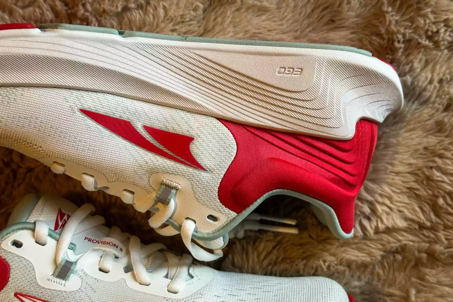A close-up of the side of the Altra Provision 8 Womenâs Support Road Running Shoe on a fuzzy background