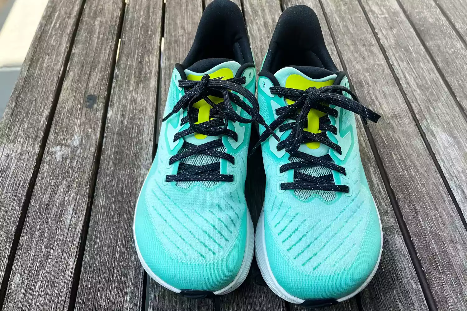 The Altra Running Experience Flow sneakers on wood