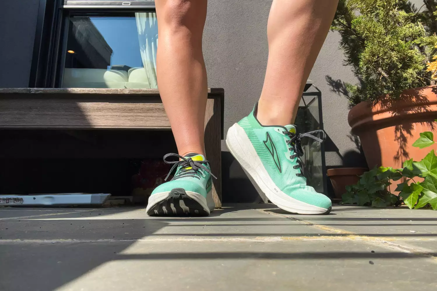 A close up of legs posing in the Altra Running Experience Flow shoes