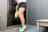 A person posing in the Altra Running Experience Flow sneakers