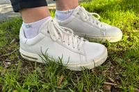 A close-up of the Birkenstock Bend Low Leather Sneakers worn in grass