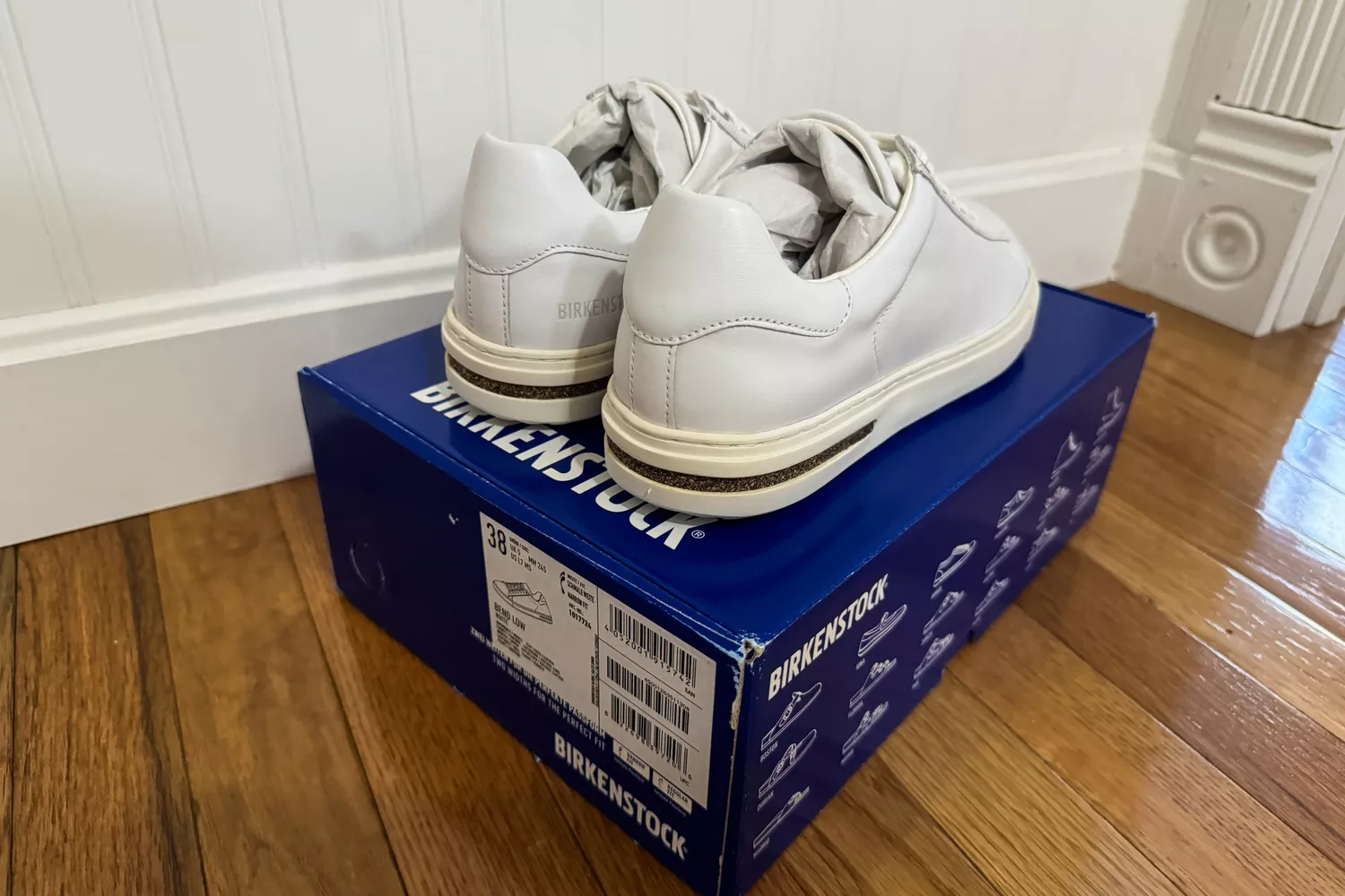 The Birkenstock Bend Low Leather Sneakers at a back angle on top of their box