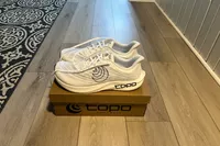 The Topo Athletic Men's Cyclone 2 shoes on top of their box