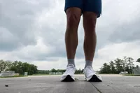 A person standing outside while wearing the Topo Athletic Men's Cyclone 2