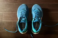 A top-view of the Topo Athletic Womenâs Ultrafly 5 shoes on a wooden floor