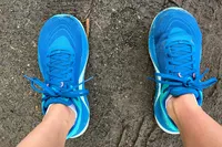 A top view of the Topo Athletic Womenâs Ultrafly 5 sneakers worn on dirt