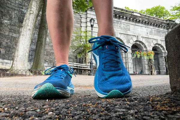 A close-up of a person's legs posing in the Topo Athletic Womenâs Ultrafly 5
