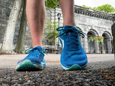 A close-up of a person's legs posing in the Topo Athletic Womenâs Ultrafly 5