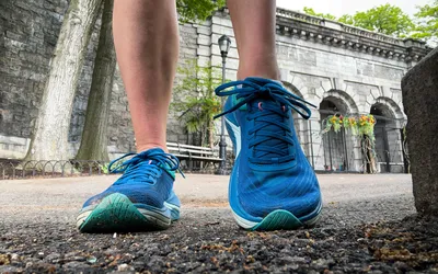 A close-up of a person's legs posing in the Topo Athletic Womenâs Ultrafly 5
