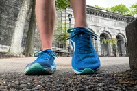 A close-up of a person's legs posing in the Topo Athletic Womenâs Ultrafly 5