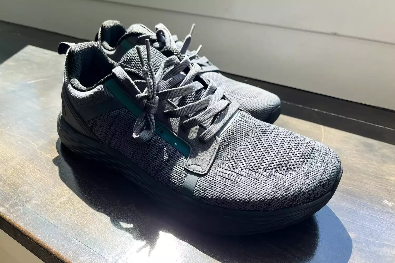 The WHITIN Men's Wide Toe Box + Zero Drop Sole Road Running Shoes on wood in sunlight