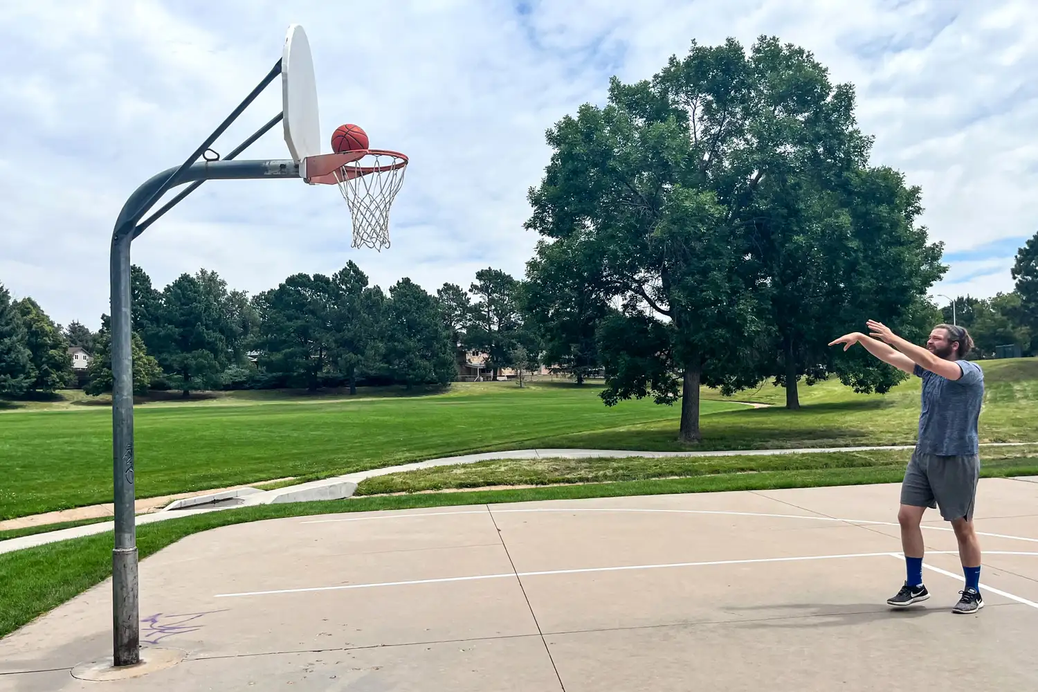 A person shoots the Wilson Evolution Game Basketball