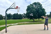 A person shoots the Wilson Evolution Game Basketball