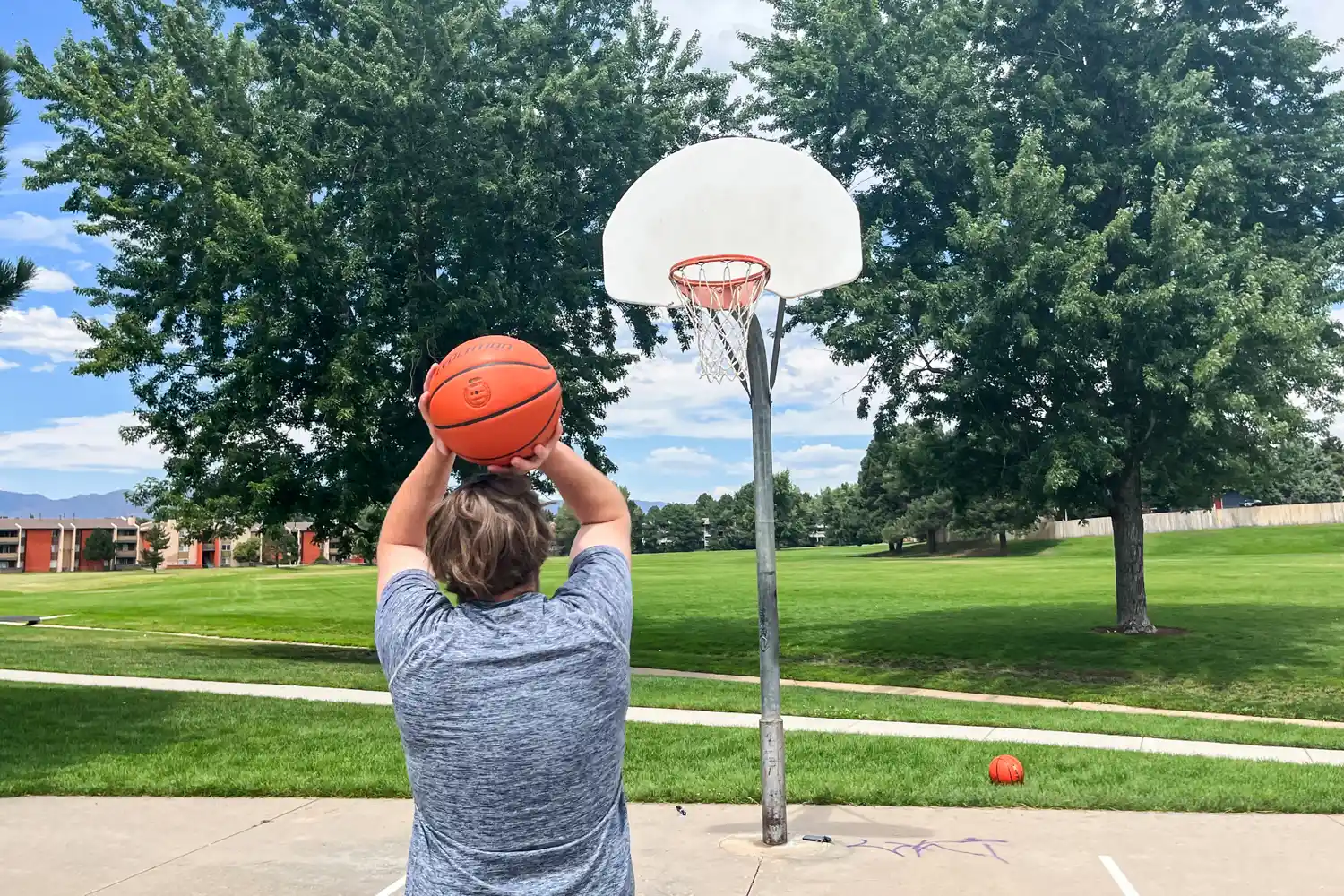 A person shoots the Wilson Evolution Game Basketball