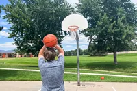 A person shoots the Wilson Evolution Game Basketball