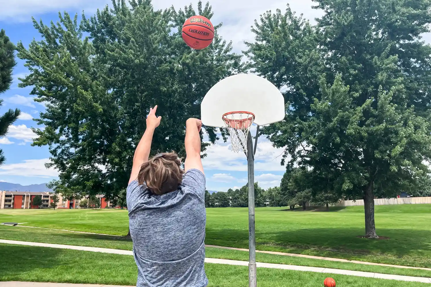 A person shoots the Wilson Evolution Game Basketball