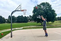 A person shoots the Wilson Evolution Game Basketball