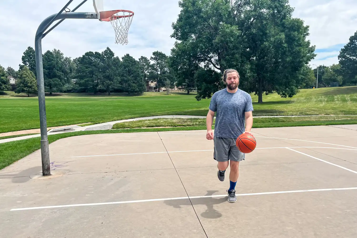 A person dribbles the Wilson Evolution Game Basketball