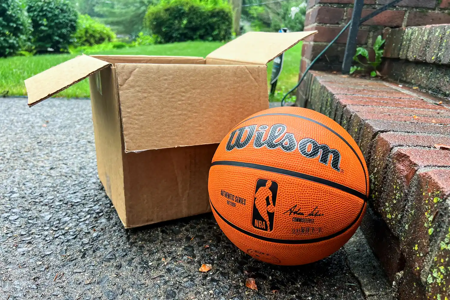The Wilson NBA Authentic Outdoor Basketball next to a cardboard box