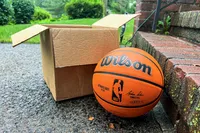 The Wilson NBA Authentic Outdoor Basketball next to a cardboard box